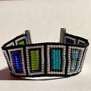 Handcrafted on a loom is this bracelet named “Flattened.”